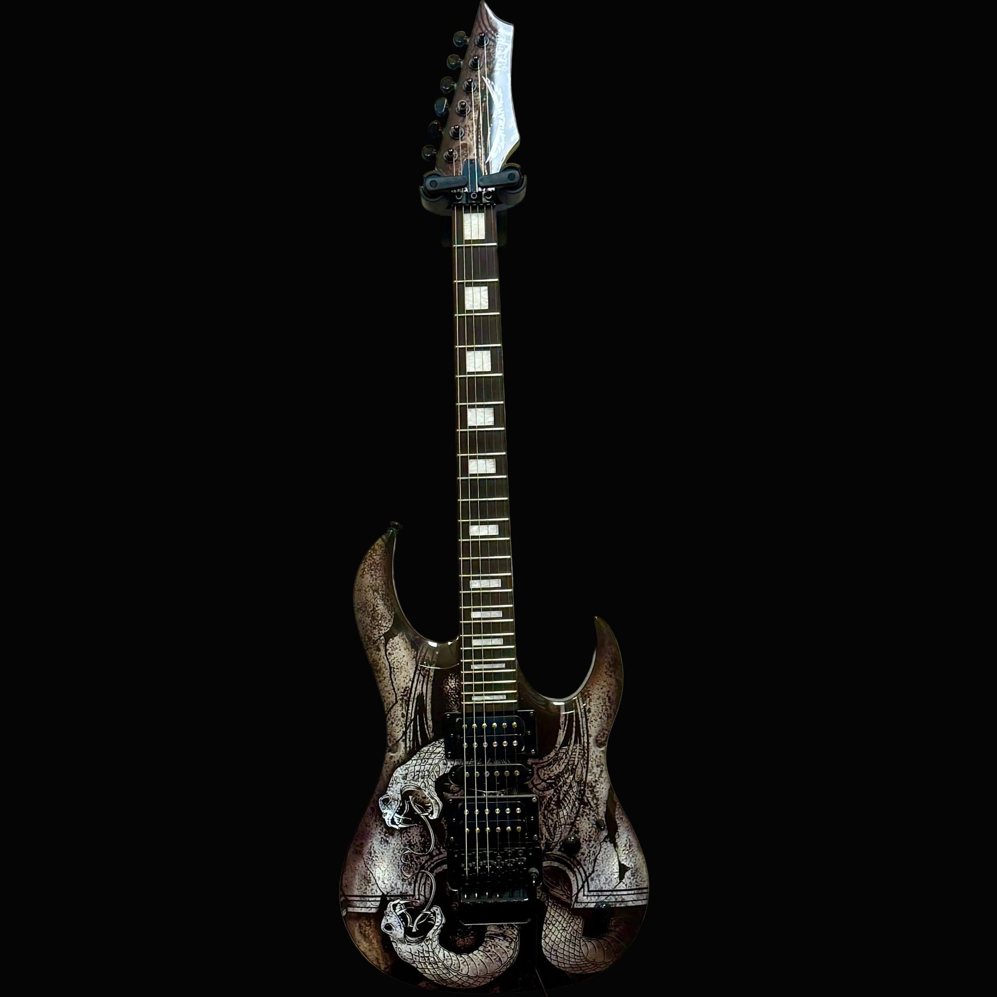 Electric guitar with a black and white design on a beige wall