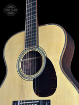 Front angle of Martin Custom Shop OM 42 Style Adirondack/Wild Grain East Indian Rosewood.