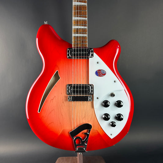 Red and white electric guitar on a gray background
