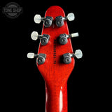 Close-up of a red guitar headstock with tuning pegs on a black background, featuring 'Tone Shop' logo.