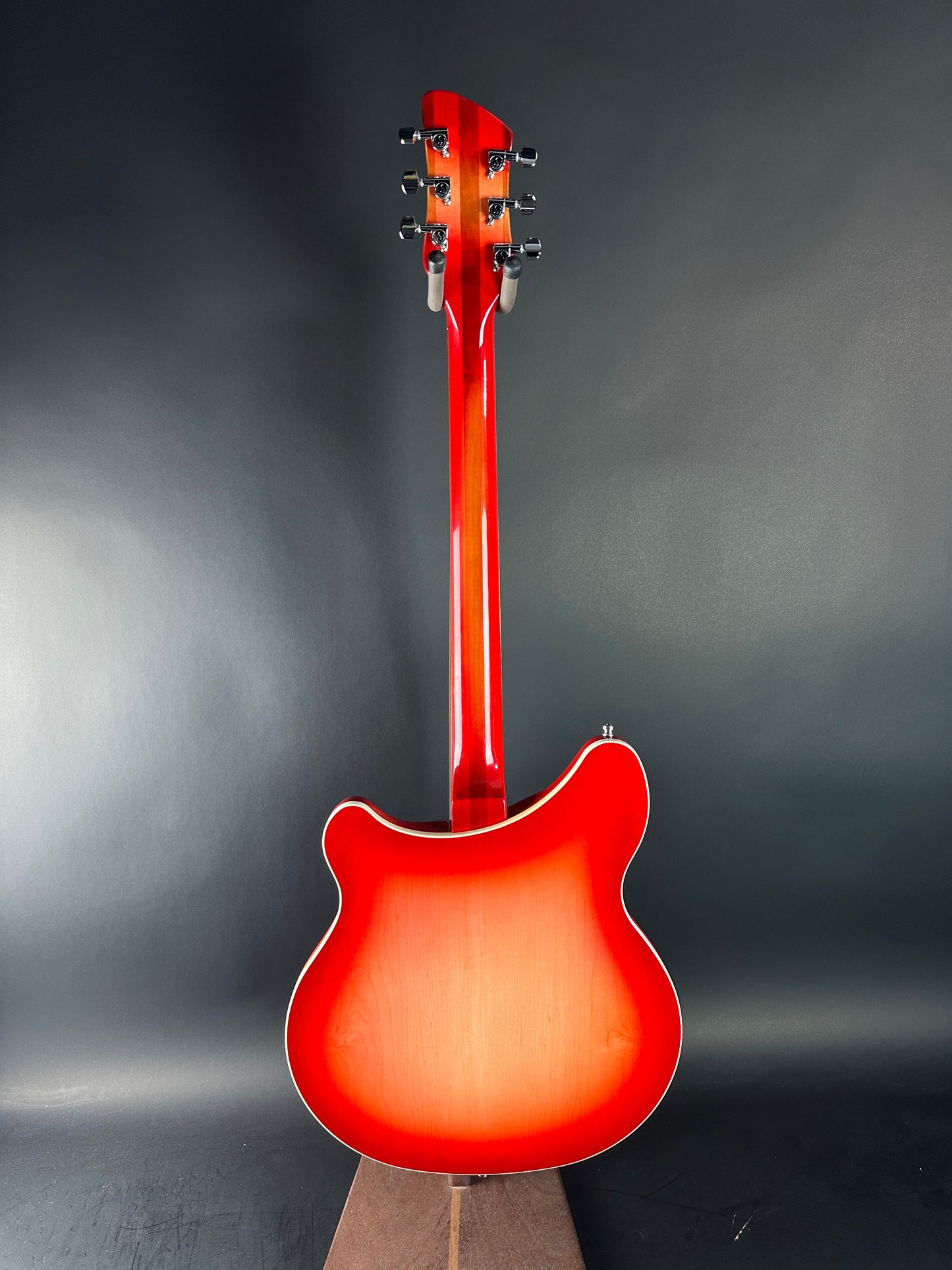 Red electric guitar on a dark gray background