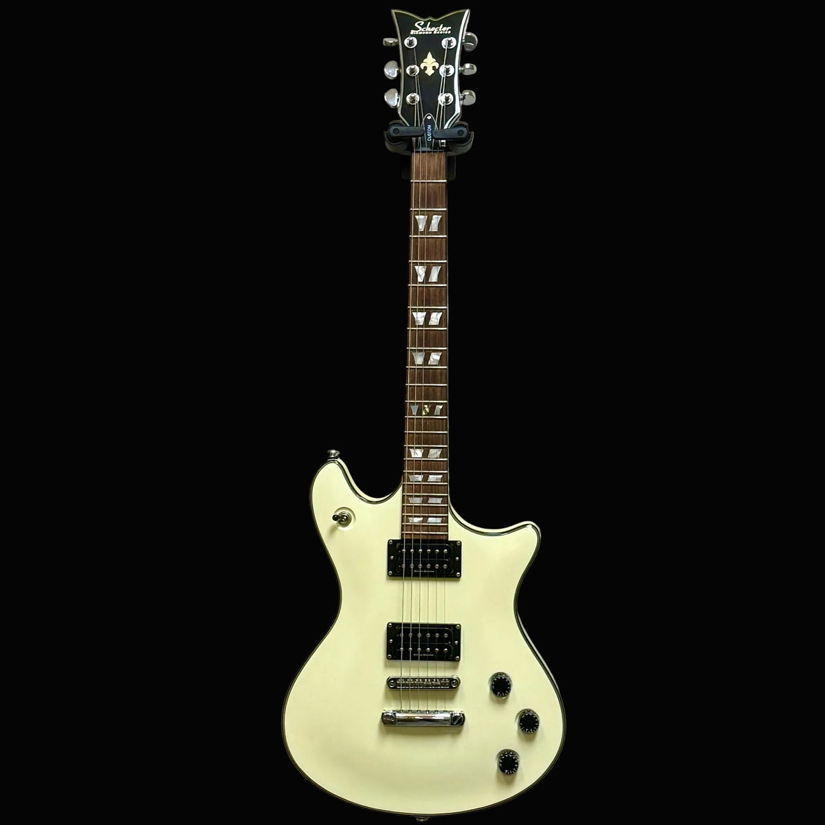 White electric guitar on a textured wall