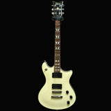 White electric guitar on a textured wall