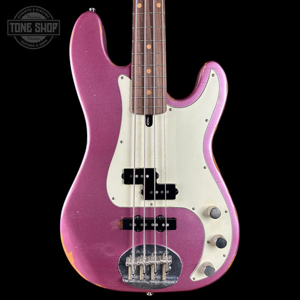 Purple electric bass guitar with a white pickguard on a black background, featuring the Tone Shop logo.