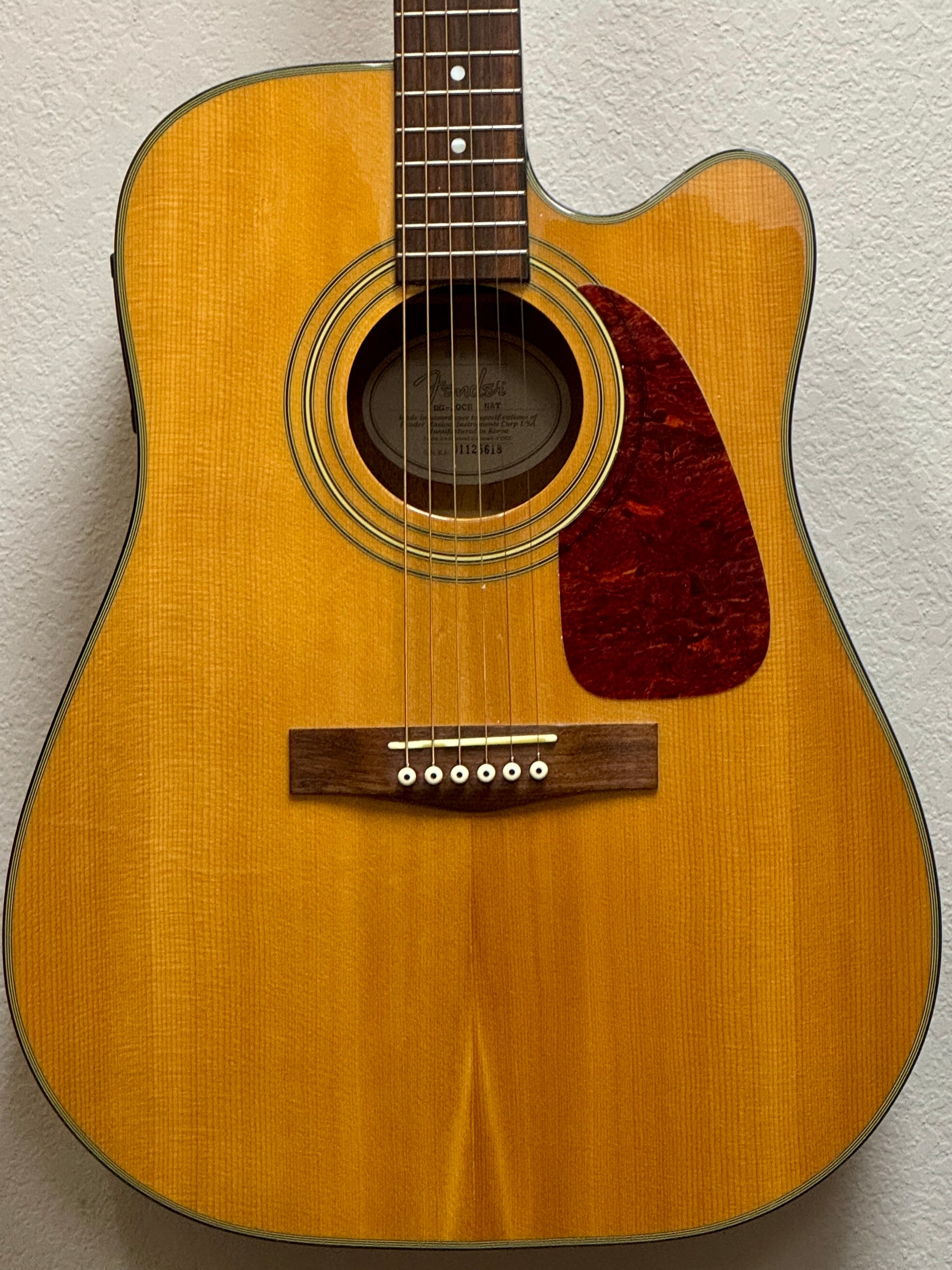 Acoustic guitar with a sunburst finish on a light gray background