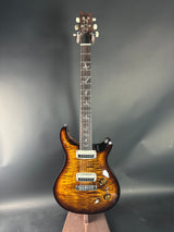 Electric guitar with a sunburst finish on a gray background