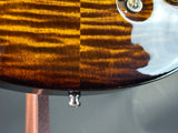 Close-up of a guitar's wood grain and hardware