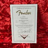 Fender certificate of authenticity on a red textured surface