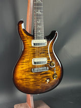 Close-up of a brown electric guitar on a dark background