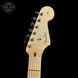 Close-up of a Fender guitar headstock on a black background