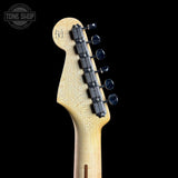 Guitar headstock with tuning pegs on a black background, featuring 'Tone Shop' logo.