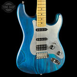 Blue electric guitar with a visible brand logo on a black background