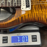 Guitar on a digital scale displaying weight