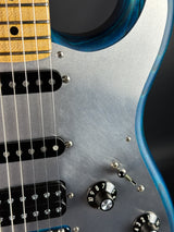 Close-up of a guitar with metallic finish and visible strings