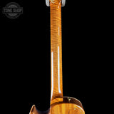 Close-up of the neck and lower body of an electric guitar with a glossy flamed maple wood finish, shown against a solid black background.