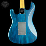 Blue electric guitar with a visible brand logo on a black background