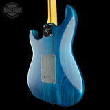 Blue electric guitar body with a visible brand logo on a black background