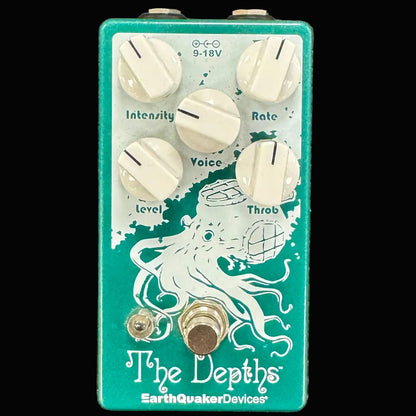Guitar effects pedal with 'The Depths' design on a textured surface