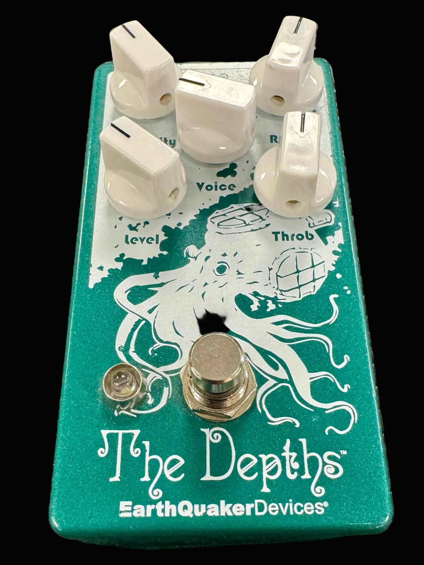 Green guitar effects pedal with white octopus design and 'EarthQuaker Devices' branding on a textured surface.