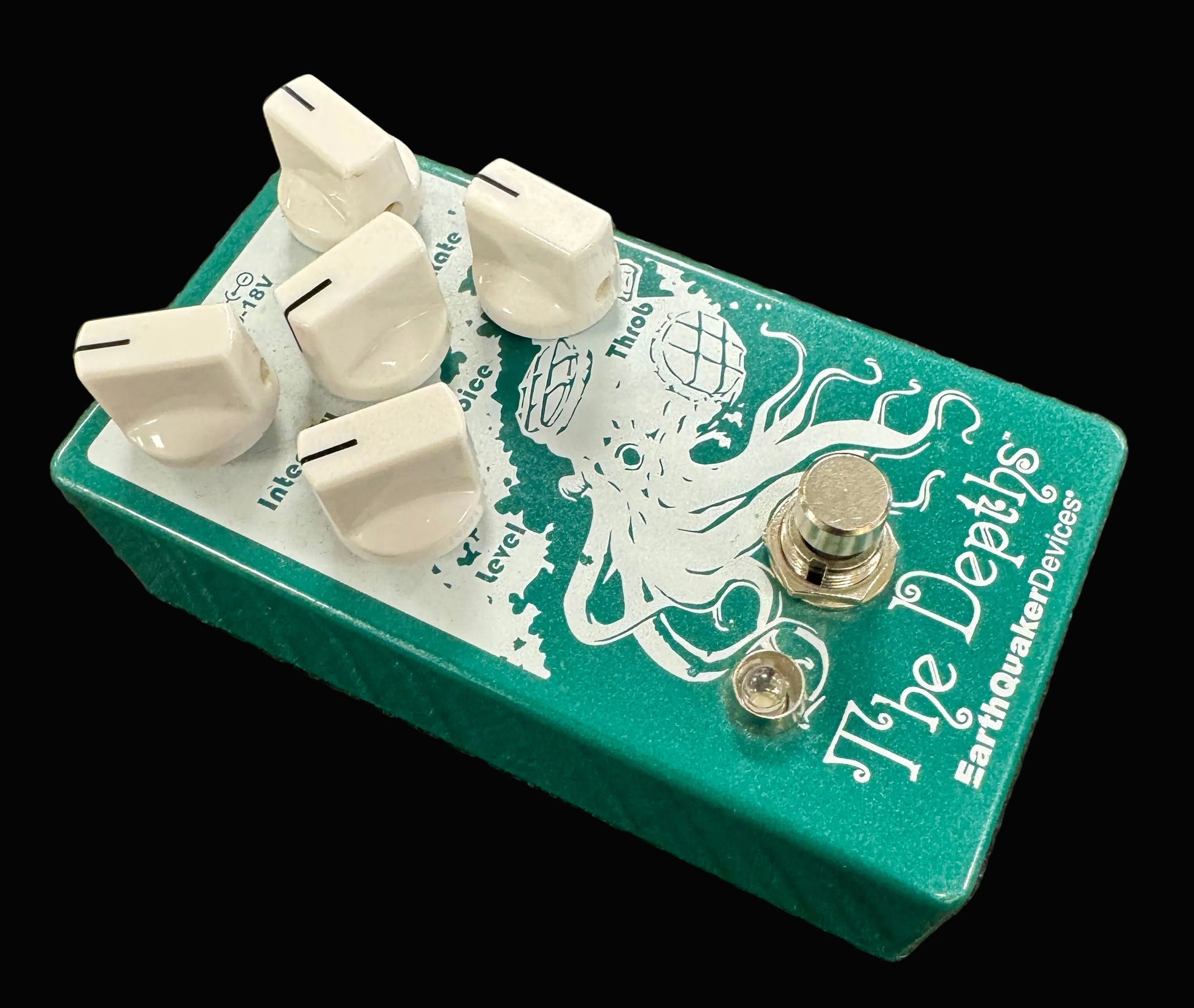 Guitar effects pedal with 'The Depths' design on a textured surface