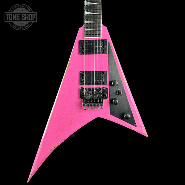 A bright pink electric guitar with a black pickguard and black hardware, shown against a solid black background. A Tone Shop watermark is visible in the top-left corner.