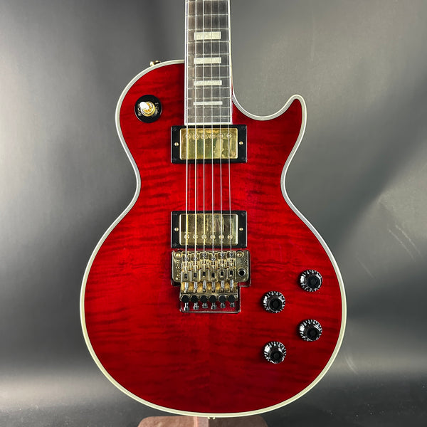 Red electric guitar on a gray background