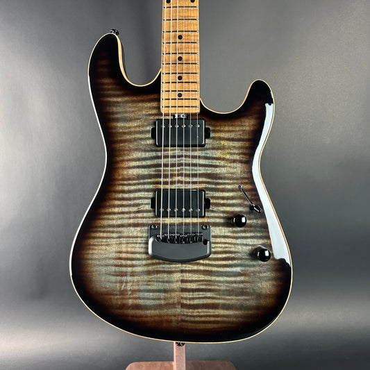 Electric guitar with a wood finish on a gray background