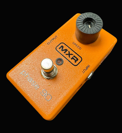 Orange MXR guitar effects pedal on a textured surface