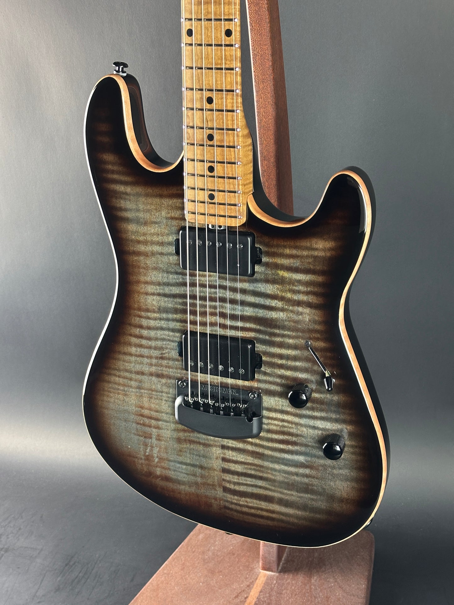 Electric guitar with a sunburst finish on a gray background