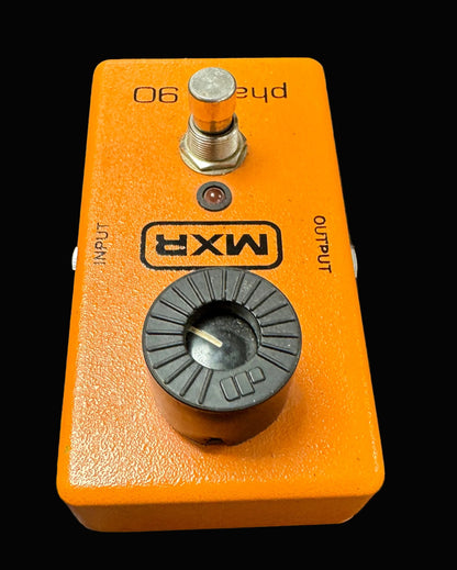 Orange MXR guitar effects pedal on a textured surface