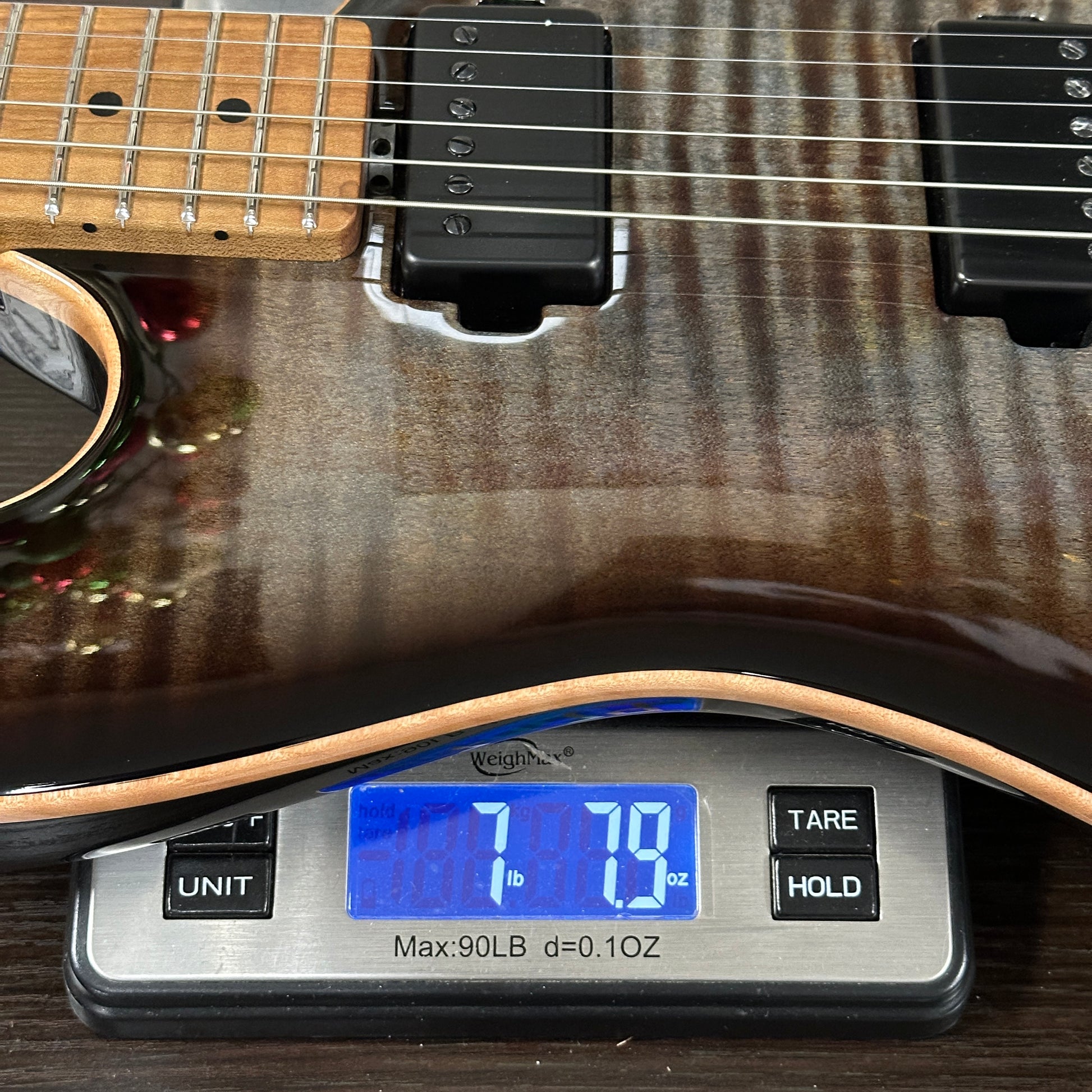 Guitar on a digital scale displaying weight