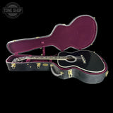 A black acoustic guitar displayed inside an open hard case with a burgundy interior, set against a solid black background. A 'TONE SHOP' watermark is visible in the top-left corner.