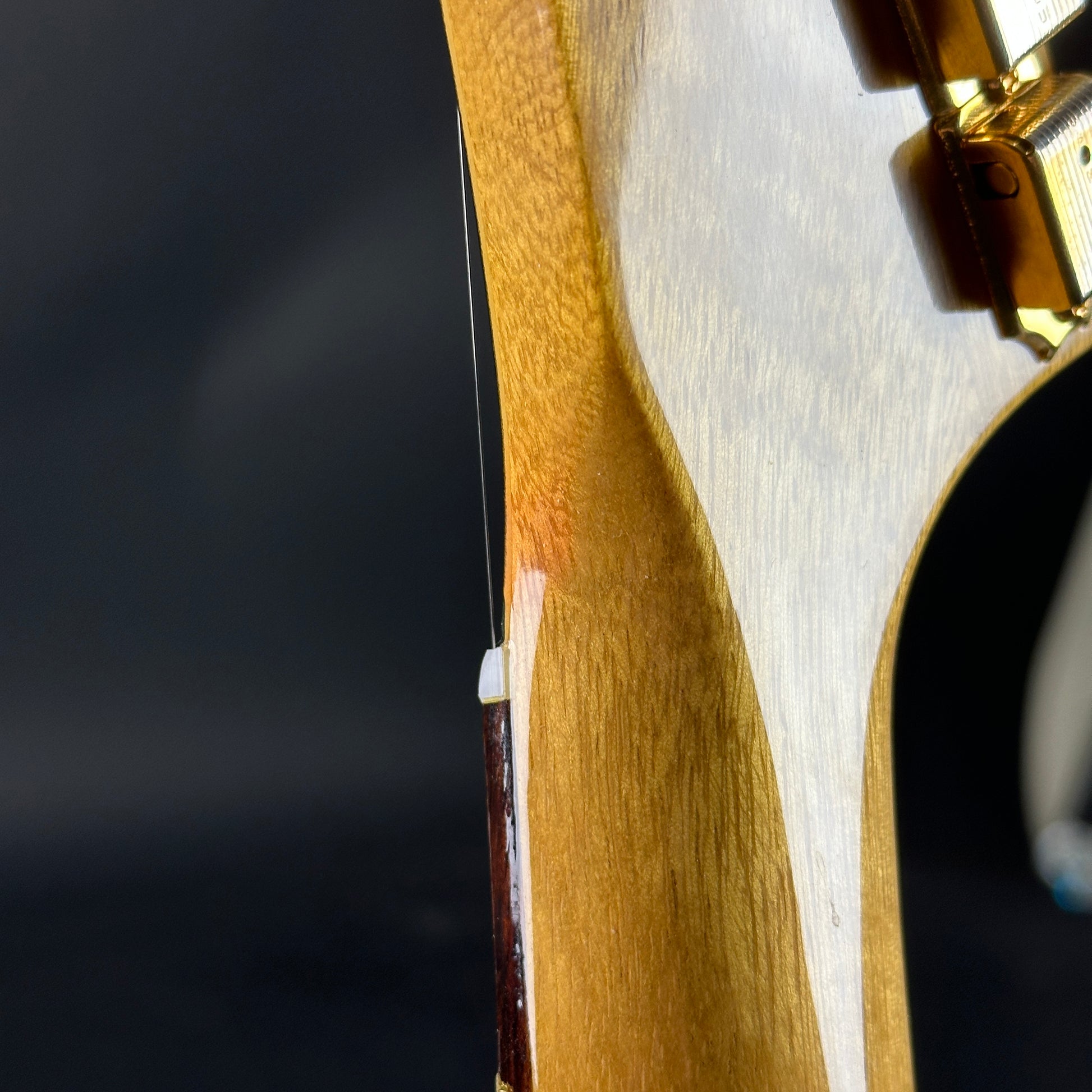 Discoloration on headstock of Used 2022 Gibson Custom Shop 1958 Explorer Reissue Korina Black Pickguard.