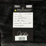 A black hangtag for aPRS The Paul Reed Smith Guitar, model C024, with handwritten details on a white background, placed on a black furry surface.