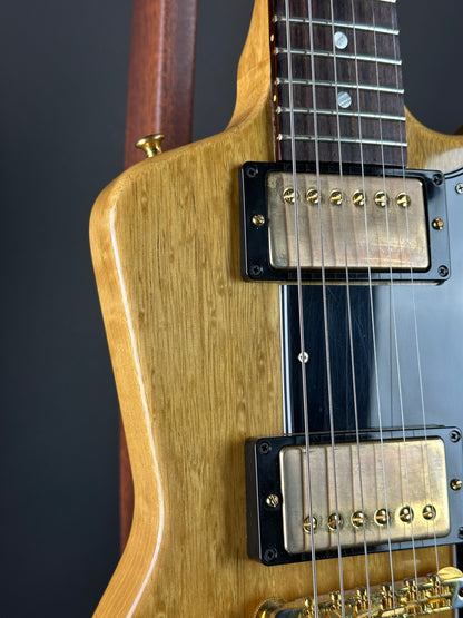 Close-up of a guitar's pickups and neck on a dark background