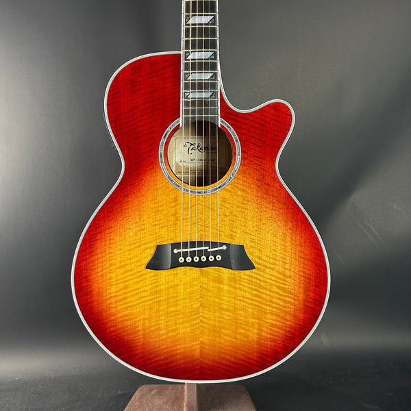 Acoustic guitar with a sunburst finish on a dark background