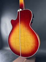 Close-up of a wooden acoustic guitar on a dark background