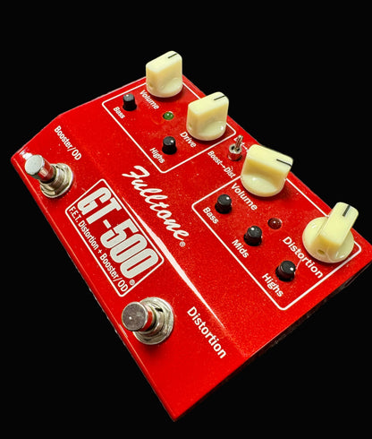 Red Fulltone FT-500 guitar effects pedal on a textured surface
