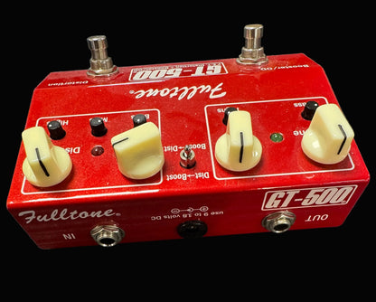Red Fulltone GT-500 guitar effects pedal on a textured surface