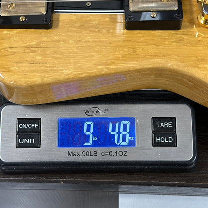 Digital scale displaying weight of a wooden object