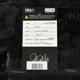 A product tag for aPRS Collection DGT strings, featuring a black and white design with handwritten details, placed on a black textured faux fur background.