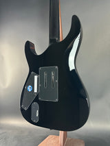 Black electric guitar body on a reflective surface