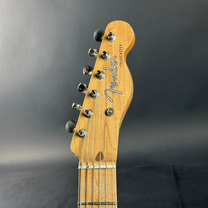 Fender electric guitar headstock on a gray background