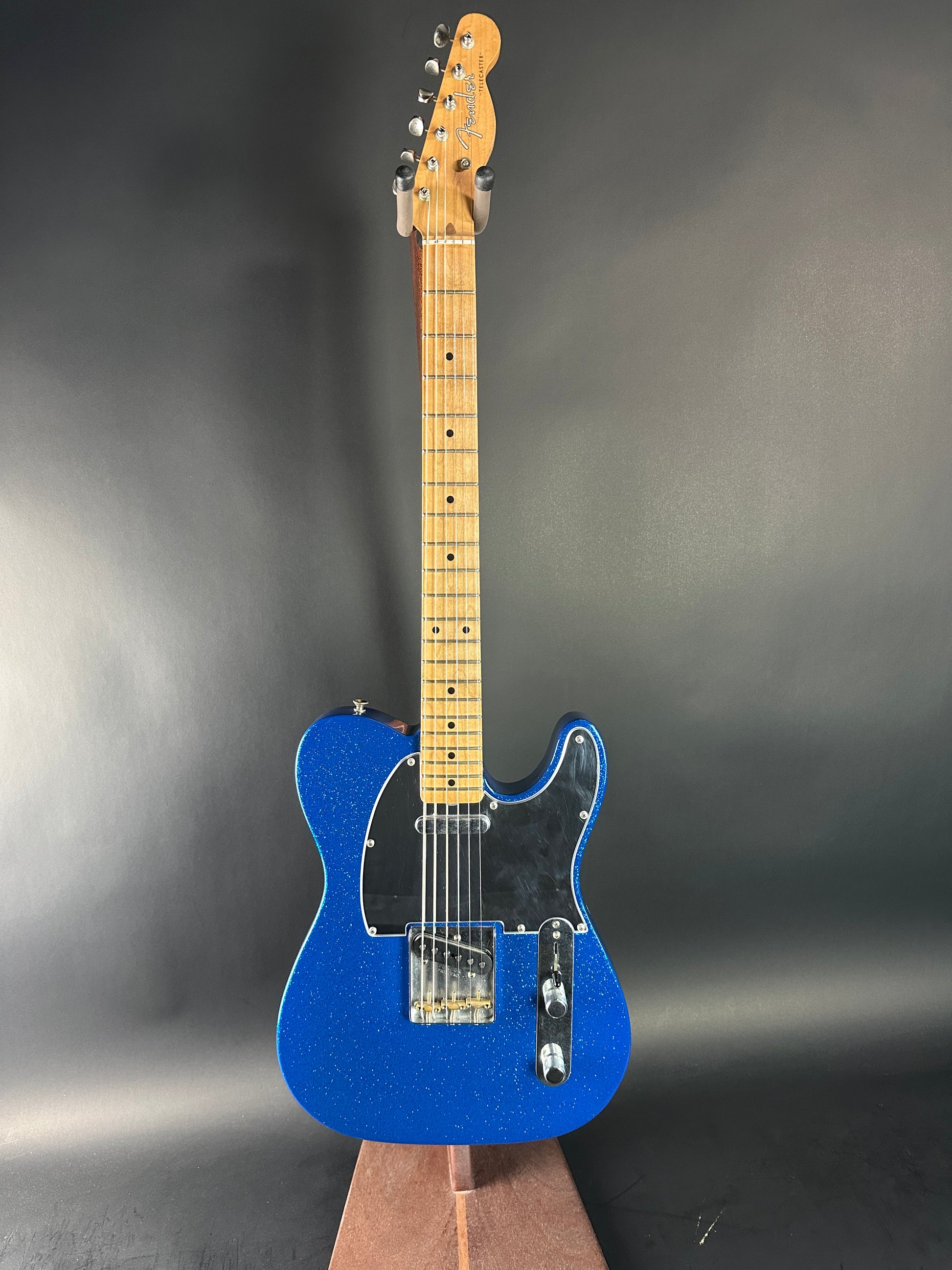Blue electric guitar on a gray background