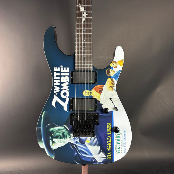 Guitar with 'White Zombie' branding and artistic design on a dark background