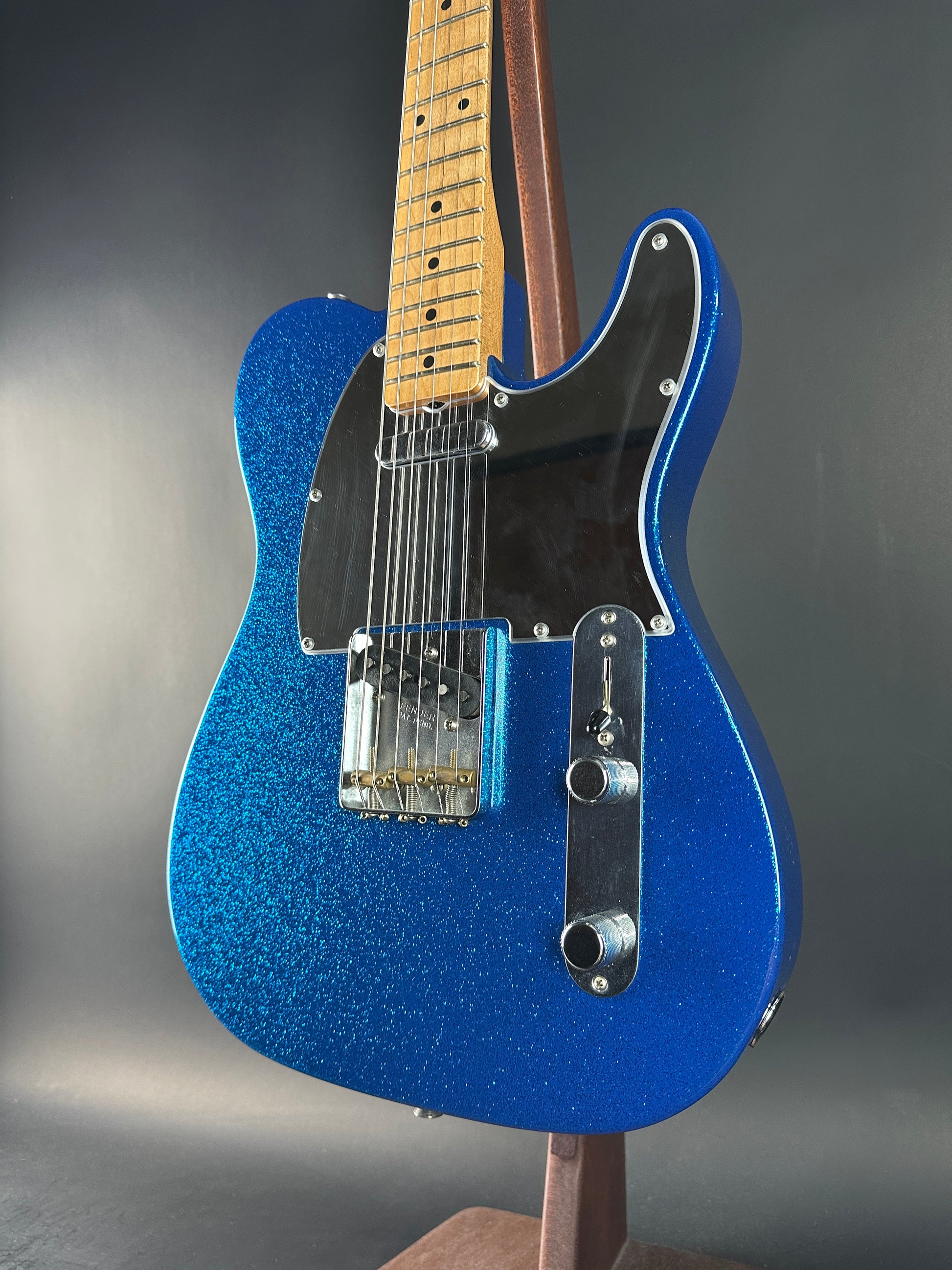 Blue electric guitar on a gray background