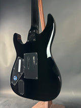 Black electric guitar body on a reflective surface