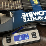 Guitar on a digital scale displaying weight