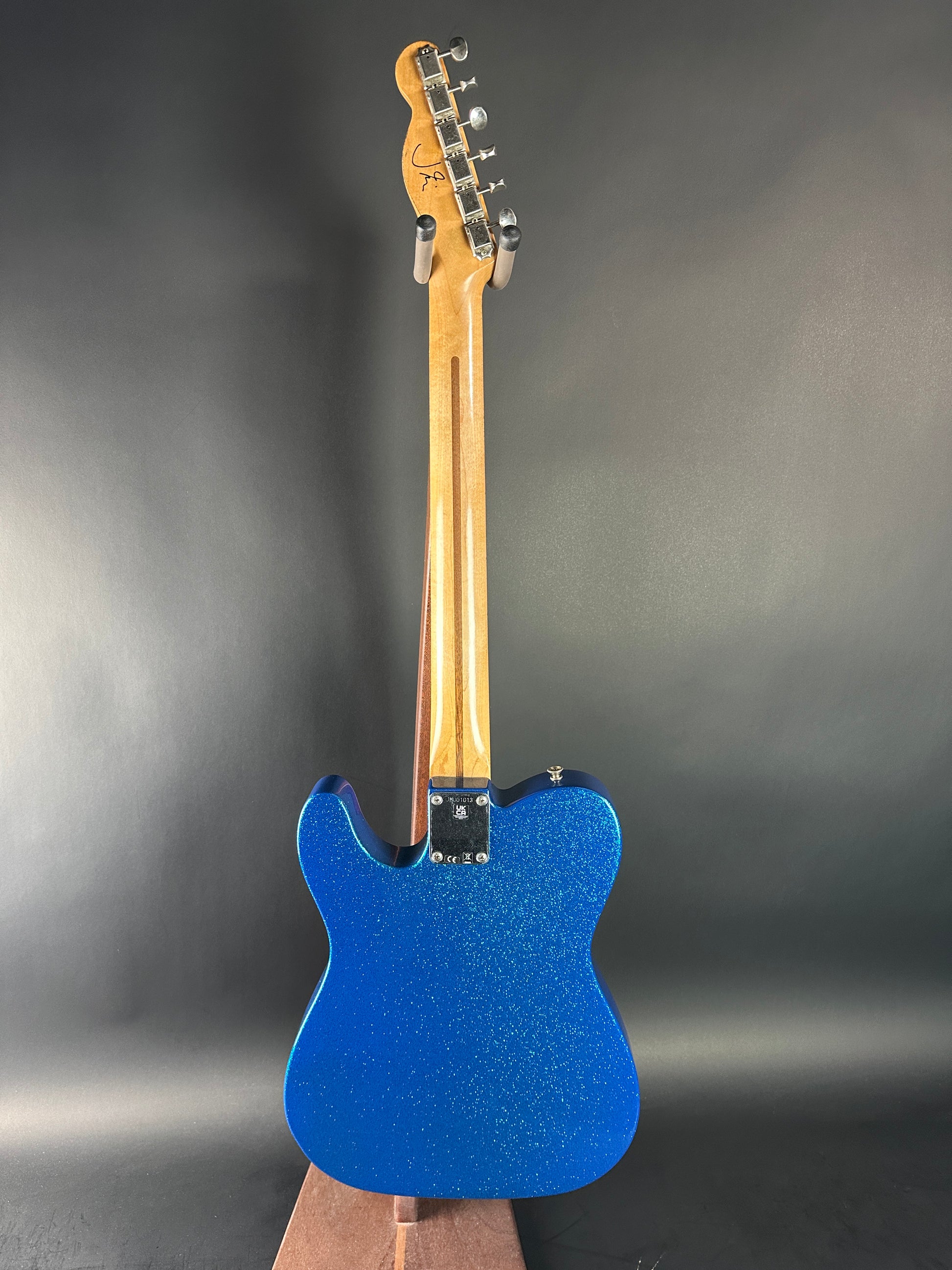 Blue electric guitar on a gray background