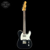 A classic Fender Telecaster electric guitar with a black body, white pickguard, and a natural wood neck, shown against a solid black background. A 'TONE SHOP' watermark is visible in the top-left corner.